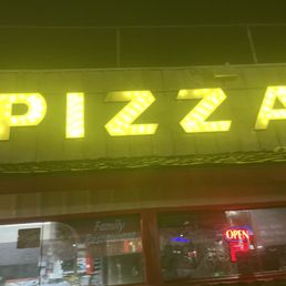 Exterior outside entrance of Chico's Pizza Parlor - Outside nighttime retro signage - Lynwood, California Exterior outside entrance of Chico's Pizza Parlor - Outside nighttime retro signage - Lynwood, California