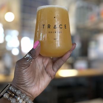 Trace Brewing - a hand holding a glass of beer - Breweries Near Me - Pittsburgh, Pennsylvania
