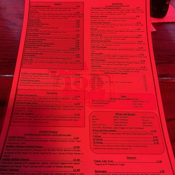 100 Proof Saloon - Food menu - A red menu board lists various food items, including starters, sandwiches, salads, favorites, sides, wings, sauces, and desserts. - American Near Me - Ocala, Florida