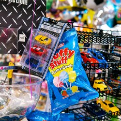Fun retail display featuring collectible toy cars, cotton candy treats, and party essentials...