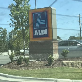 ALDI - a car driving by a sign - Grocery Near Me - Jacksonville, North Carolina