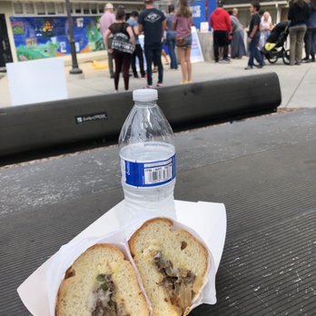 Oli’s Cheesesteaks - a bottle of water and a sandwich - Food Trucks Near Me Oli’s Cheesesteaks - a bottle of water and a sandwich - Food Trucks Near Me