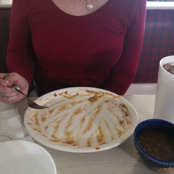 Helena's Home Cooking - a woman sitting at a table with a plate of food - Mexican Near Me - Alice, Texas Helena's Home Cooking - a woman sitting at a table with a plate of food - Mexican Near Me - Alice, Texas