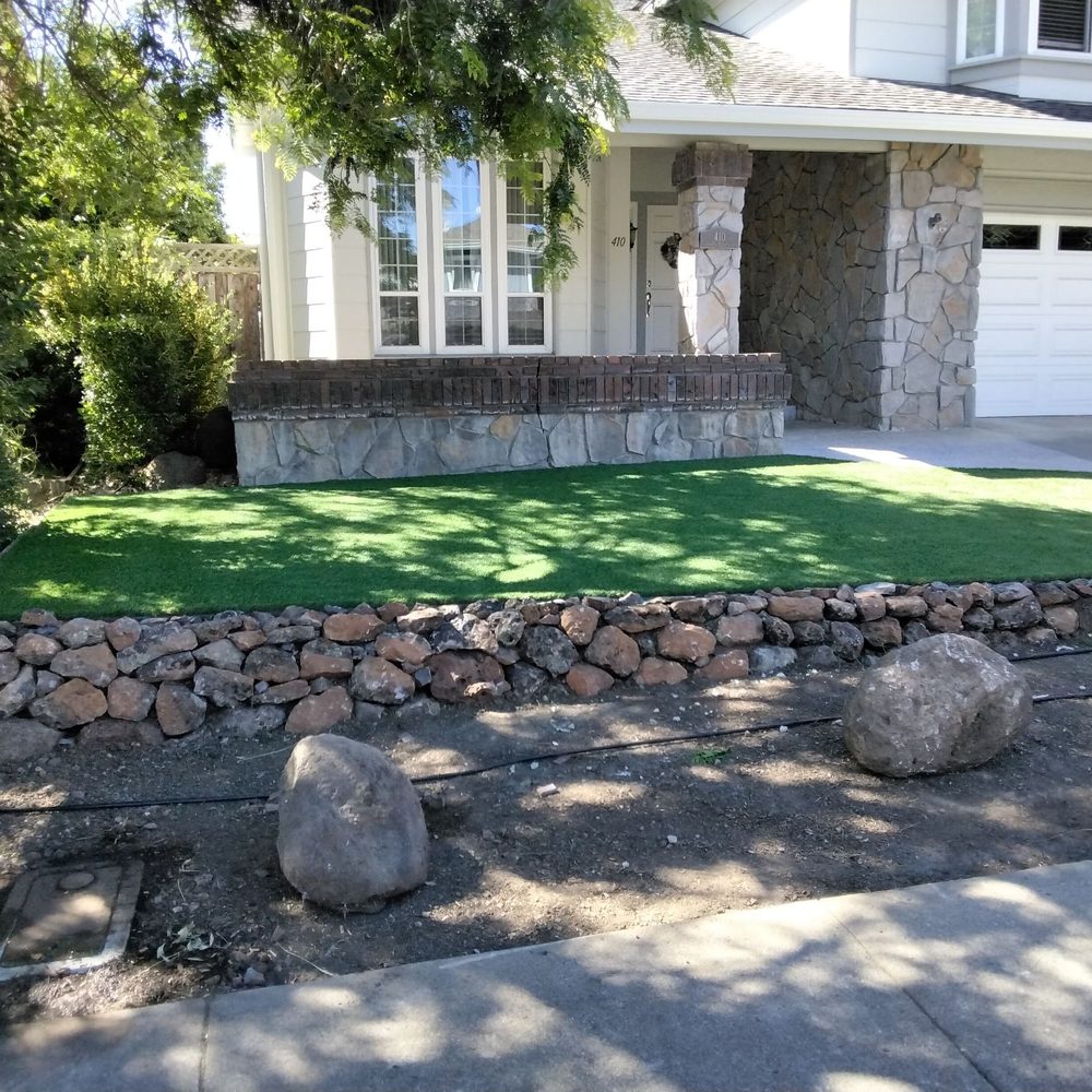 Front yard leveled with artificial turf installed. They also installed a great rock wall to create a tiered affect. Front yard leveled with artificial turf installed. They also installed a great rock wall to create a tiered affect.