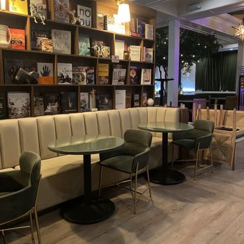 Firefly Tapas Kitchen + Bar - Decorative bookshelves with collection of famous cookbooks plus art pieces. - Tapas/Small Plates Near Me - Las Vegas, Nevada