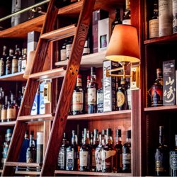 Stage Left Wine Shop - A section of liquor in the wine shop. All sorts of interesting things on those old wooden shelves.