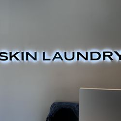 Skin Laundry - Buckhead - The logo behind the check in desk.
