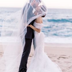 Romantic Cabo Weddings & Events - Kiss on the beach. Shot by Nadia Hung Photography.