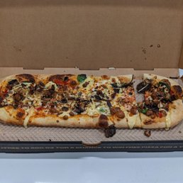 Create your own pizza: tomato sauce, shredded mozzarella, spinach, onion, sausage and garlic drizzle