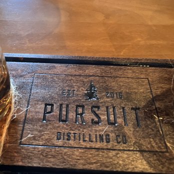 Pursuit Distilling - a glass of whiskey on a wooden table - Distilleries Near Me - Enumclaw, Washington Pursuit Distilling - a glass of whiskey on a wooden table - Distilleries Near Me - Enumclaw, Washington