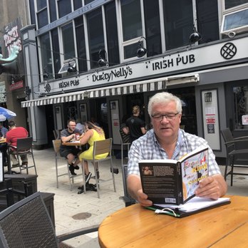 Durty Nelly's - Owner Joe McGuinness reading outside of his pub - Irish Near Me - Halifax, Nova Scotia Durty Nelly's - Owner Joe McGuinness reading outside of his pub - Irish Near Me - Halifax, Nova Scotia