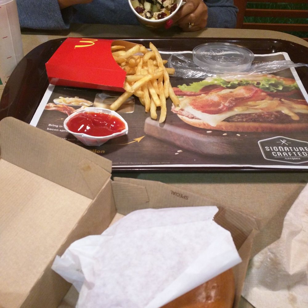 McDonald's - a man eating a hamburger and fries - Fast Food Near Me - Osseo, Wisconsin McDonald's - a man eating a hamburger and fries - Fast Food Near Me - Osseo, Wisconsin