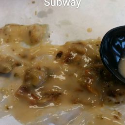 a plate of food with a spoon and sauce a plate of food with a spoon and sauce
