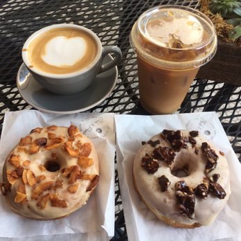 Hook And Press Donuts - Cappuccino & Maple Coconut Bacon (left), cold Bree & butterscotch walnut brittle (right) - Donuts Near Me - Santa Barbara, California Hook And Press Donuts - Cappuccino & Maple Coconut Bacon (left), cold Bree & butterscotch walnut brittle (right) - Donuts Near Me - Santa Barbara, California