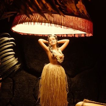 Permanent Vacation - a woman in a hula skirt under a lamp - Tiki Bars Near Me - Maitland, Florida Permanent Vacation - a woman in a hula skirt under a lamp - Tiki Bars Near Me - Maitland, Florida