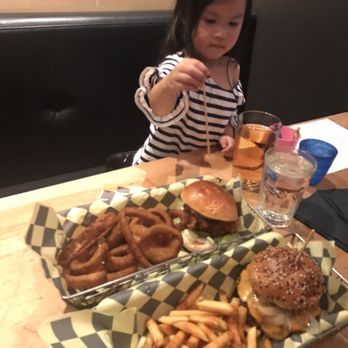 Eddie Burger + Bar - Crispy chicken burger w onion rings, Rocky Mountain burger w truffle fries, pint peach cider - Burgers Near Me - Banff, Alberta