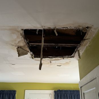 Gomez Brothers Remodeling - Before repairs. Hole caused by a leak in the roof. - Flooring Near Me