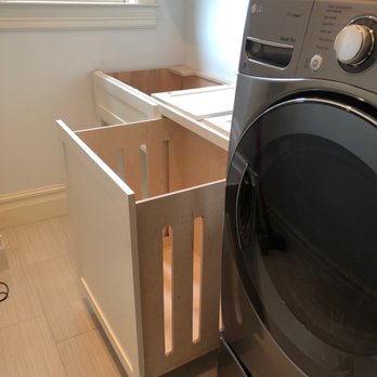 Central City Remodeling - Small custom cabinets and shelves for an upstairs laundry room on Allston St in the Heights. This pullout hamper is so convenient. - Painters Near Me - Houston, Texas Central City Remodeling - Small custom cabinets and shelves for an upstairs laundry room on Allston St in the Heights. This pullout hamper is so convenient. - Painters Near Me - Houston, Texas