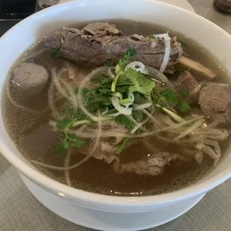 Signature Beef Noodle Soup with beef rib, beef ball, beef tripe, beef brisket, and rare beef.