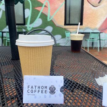 Fathom Coffee - Cold brew in the background, hot coffee and gift card in the front! - Coffee Roasteries Near Me - Virginia Beach, Virginia