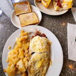 Omega Diner - 2 eggs with corned beef hash, home fries & toast and SEC sandwich