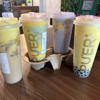 Pu'er Taiwan Tea & Coffee - (left to right) Banana Latte, Torched Creme Brulee Matcha Blend, Torched Creme Brulee Taro Milk Tea, Banana Milk - Coffee & Tea Near Me - Glendale, Arizona Pu'er Taiwan Tea & Coffee - (left to right) Banana Latte, Torched Creme Brulee Matcha Blend, Torched Creme Brulee Taro Milk Tea, Banana Milk - Coffee & Tea Near Me - Glendale, Arizona