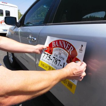 Banner Construction - a man putting a sign on a car door - General Contractors Near Me - Reno, Nevada Banner Construction - a man putting a sign on a car door - General Contractors Near Me - Reno, Nevada