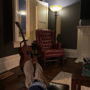 Bar: Cigar Especial - a person's feet resting on a leather chair - Cigar Bars Near Me - Nashville, Tennessee Bar: Cigar Especial - a person's feet resting on a leather chair - Cigar Bars Near Me - Nashville, Tennessee