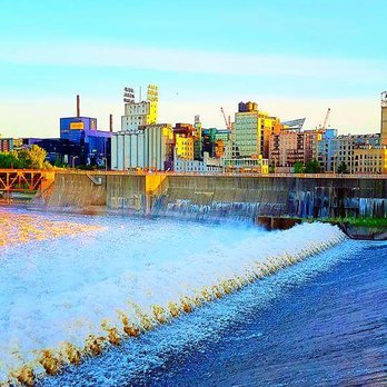 Stone Arch Bridge - View of the dam and the city and the beginning of the bridge to the far left. - Landmarks & Historical Buildings Near Me - Minneapolis, Minnesota Stone Arch Bridge - View of the dam and the city and the beginning of the bridge to the far left. - Landmarks & Historical Buildings Near Me - Minneapolis, Minnesota