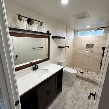 Jacob Construction - a bathroom with a sink, toilet, and shower - General Contractors Near Me - Sausalito, California Jacob Construction - a bathroom with a sink, toilet, and shower - General Contractors Near Me - Sausalito, California