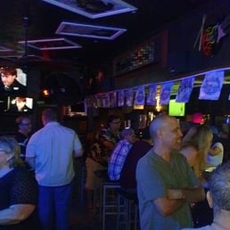 a crowd of people at a bar a crowd of people at a bar