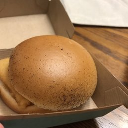 a hand holding a hamburger in a box a hand holding a hamburger in a box