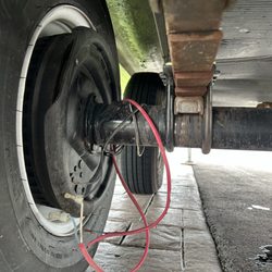 On The Road Again RV Service - Photo of shifted axle and wiring sheared off by axle rotation due to non-welded spring seats.