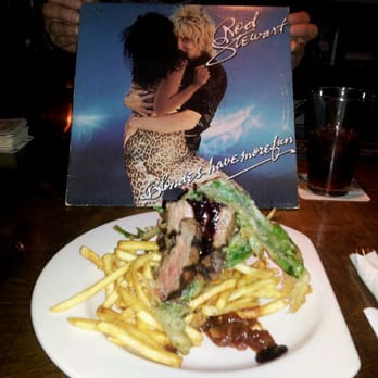The Crow's Nest - Steak Frites in yummy sauce with the clever record album menu in the background. - Breakfast & Brunch Near Me - Maplewood, Missouri