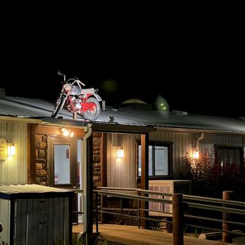 Silver Sage Inn - Exterior entrance at night (enter under the rooftop motorcycle) - Hotels Near Me - Moab, Utah