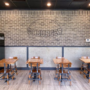 Go Burger - tables and chairs in front of a brick wall - Burgers Near Me - Ridge, New York