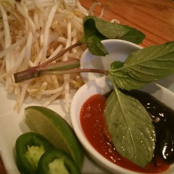 Saigon Spring Restaurant - Condiments for the pho, bean sprouts, Thai basil, lime, 2 jalapeño slices, hoison, and spicy chili sauce - Vietnamese Near Me - Clifton Park, New York Saigon Spring Restaurant - Condiments for the pho, bean sprouts, Thai basil, lime, 2 jalapeño slices, hoison, and spicy chili sauce - Vietnamese Near Me - Clifton Park, New York