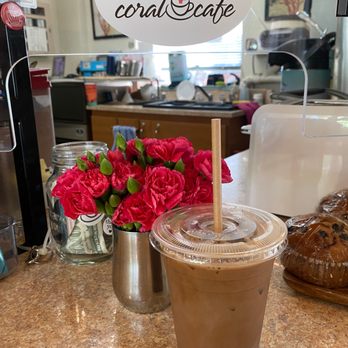 Coral Cafe - a cup of iced coffee and a sign that says ring bell coral cafe - Coffee & Tea Near Me - Honolulu, Hawaii