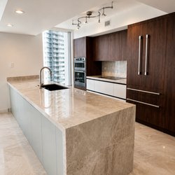 King of Quartz and Granite Countertops - Quartzite waterfall island. Polished finish, fabricated in-house. kingofquartzfl.com