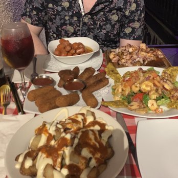 Triana - From front to back- papas bravas, ham and cheese croquettes, alcaparras, octopus salad, grilled octopus, and regional sausage. - Spanish Near Me - San Juan, Puerto Rico
