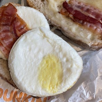 Dunkin' - Sourdough Breakfast sandwich. Cheese on part of the sandwich, sparse and these eggs..... Feel these came from the freezer. - Donuts Near Me - Bridgeton, Missouri