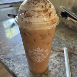 a cup of iced coffee on a counter