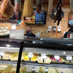 a variety of meats in a display case a variety of meats in a display case