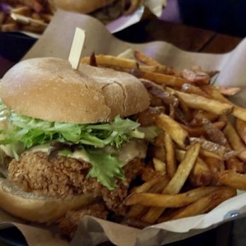 Stock & Barrel - Mother Clucker - Buttermilk Fried Chicken + Havarti + Garlic Aioli + Bourbon Onions + Tomato + Greens - Burgers Near Me - Knoxville, Tennessee