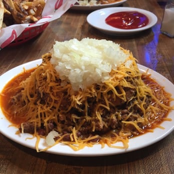 Mike's Chili Parlor - Chili burger with beans, cheddar cheese, and onions along with an order of fries. - Dive Bars Near Me - Seattle, Washington