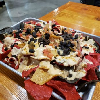 Sunriver Brewing -Oakway Pub - Pub Nachos... with black beans, beer cheese, olives and pico de gallo. - New American Near Me - Eugene, Oregon Sunriver Brewing -Oakway Pub - Pub Nachos... with black beans, beer cheese, olives and pico de gallo. - New American Near Me - Eugene, Oregon