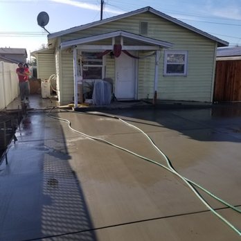 Prestige Construction Company - a man washing a driveway - General Contractors Near Me - Corona, California