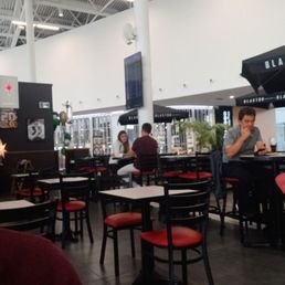 people sitting at tables in a restaurant