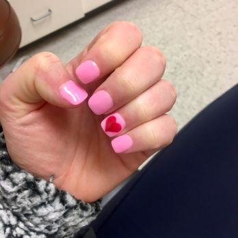 Fashion Nails - Pink dip with a red gel heart and a gel clear coat on top. Love my Valentine's Day nails - Nail Salons Near Me - Fenton, Missouri