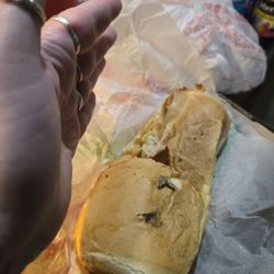 Joe's Pizzeria - Garlic Bread. Smaller than a woman's hand.